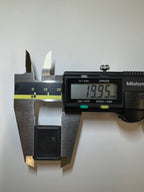 Measuring the push button's height at 19.95mm with a digital caliper.